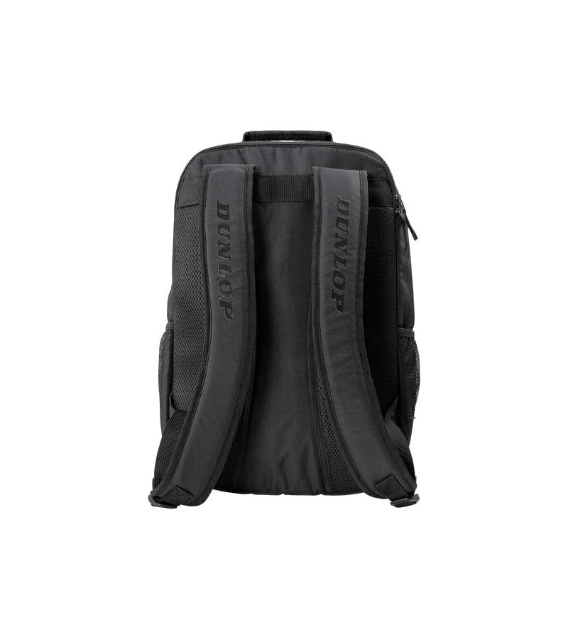 The Dunlop Team Backpack - Black, created by Dunlop, is displayed from the back against a white background. It includes two padded shoulder straps, mesh side pockets, and a zippered main compartment for easy access. This backpack is designed to provide ample space and reliable racket protection.