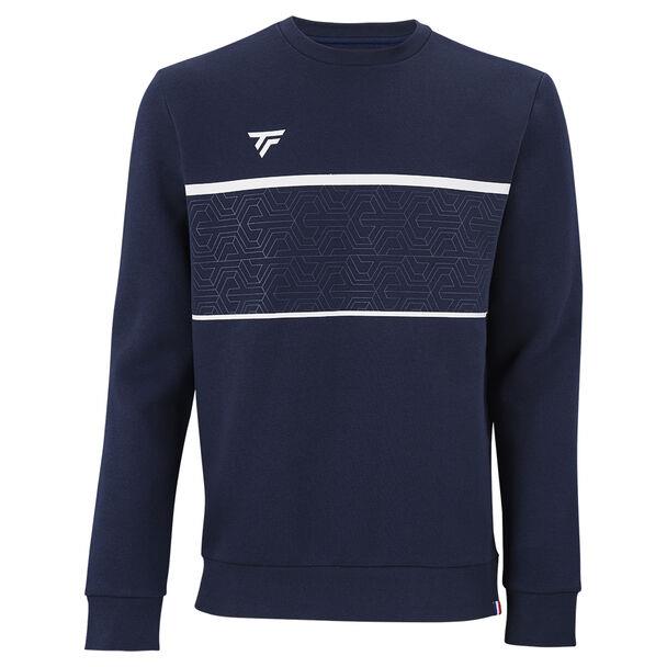 The Tecnifibre Men's Team Badminton Sweater in Marine is a stylish addition to your wardrobe, boasting a geometric pattern across the chest with white horizontal stripes framing it. A small logo adorns the left side of the chest, and ribbed cuffs and waistband offer comfort with every wear.