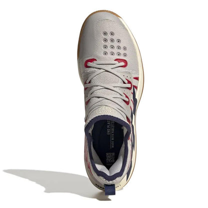 A top view of the ADIDAS Stabil Next Gen 2.0 Primeblue men's indoor badminton shoe in grey with navy and red accents, showcasing a high-top design with visible perforations near the toes. The BOOST technology enhances comfort, while the shoe is displayed on a plain white background with a shadow underneath.