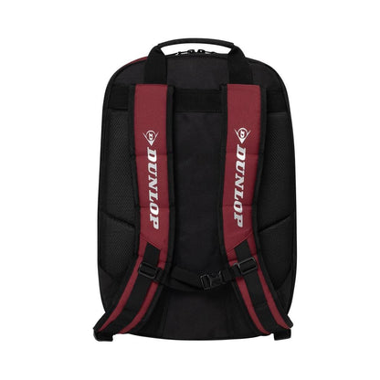 The image displays a Dunlop CX Performance Badminton Backpack in black and red, featuring maroon straps with "Dunlop" printed on each in white text. It has a sturdy rectangular shape, a top handle, and a specialized holder for rackets, ensuring easy transport.