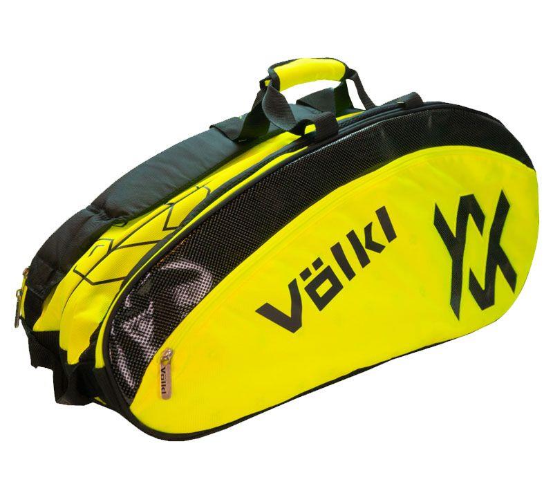 The Volkl Combi 6 Racket Badminton Bag in black and neon yellow showcases a geometric logo, "Volkl" branding, visible racket compartments, and a thermal climate-controlled lining to safeguard your gear. It also includes a sturdy handle on top for easy carrying.