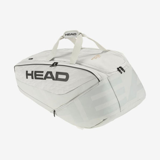 The HEAD Pro X Racket Bag - XL - YUBK, preferred by Novak Djokovic, is a roomy sports bag in white with striking black branding. It features CCT+ climate control technology and includes several compartments, zippers, and durable top handles for maximum convenience and protection.