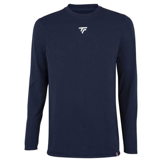 The Tecnifibre Men's Badminton Seamless Baselayer in Marine is a navy blue long-sleeve shirt ideal for cold-weather sports training. It features a crew neck and displays a small white logo with stylized letters on the chest, ensuring both comfort and performance.