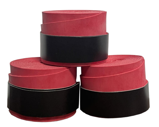 Three rolls of Badminton HQ's red overgrip, recognized for excellent comfort and shock absorption, stacked in a pyramid formation. Each roll features a protective black layer on the outside.