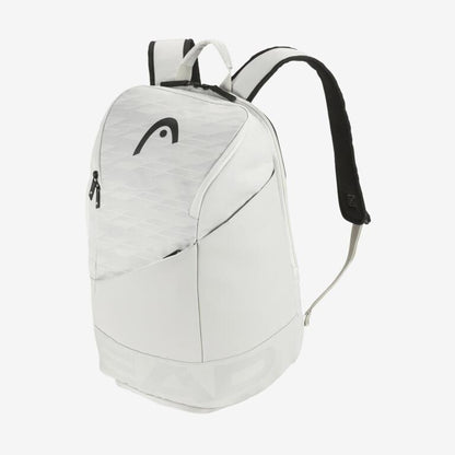 The HEAD Pro X 28L Backpack - YUBK - M showcases a sophisticated white design, complete with a zippered front pocket and adjustable black shoulder straps. The minimalist, contemporary appearance is accentuated by the HEAD logo on the front, and it offers a ventilated shoe compartment for extra convenience.