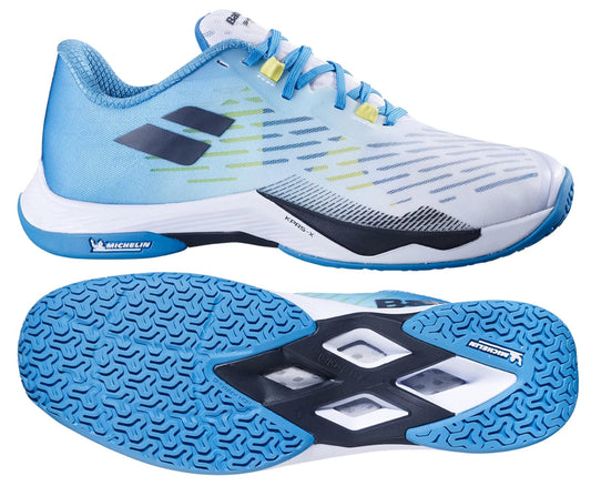 The Babolat Shadow Tour 5 Men's Badminton Shoes - Algier Blue feature light blue and white colors with blue and yellow accents, a black logo, and blue patterned soles—ideal for indoor courts. Shown from side and bottom angles.