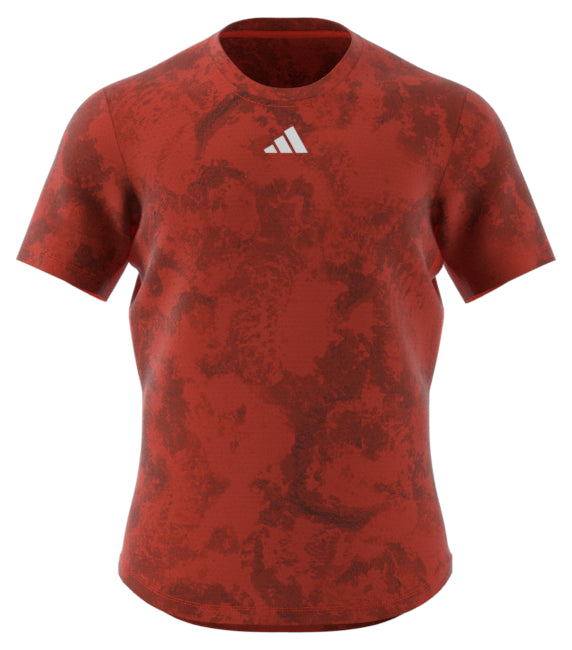 The ADIDAS Paris Mens Freelift Badminton T-Shirt in red is a stylish short-sleeve design, offering the benefits of HEAT.RDY technology and showcasing a small white adidas logo on the chest.