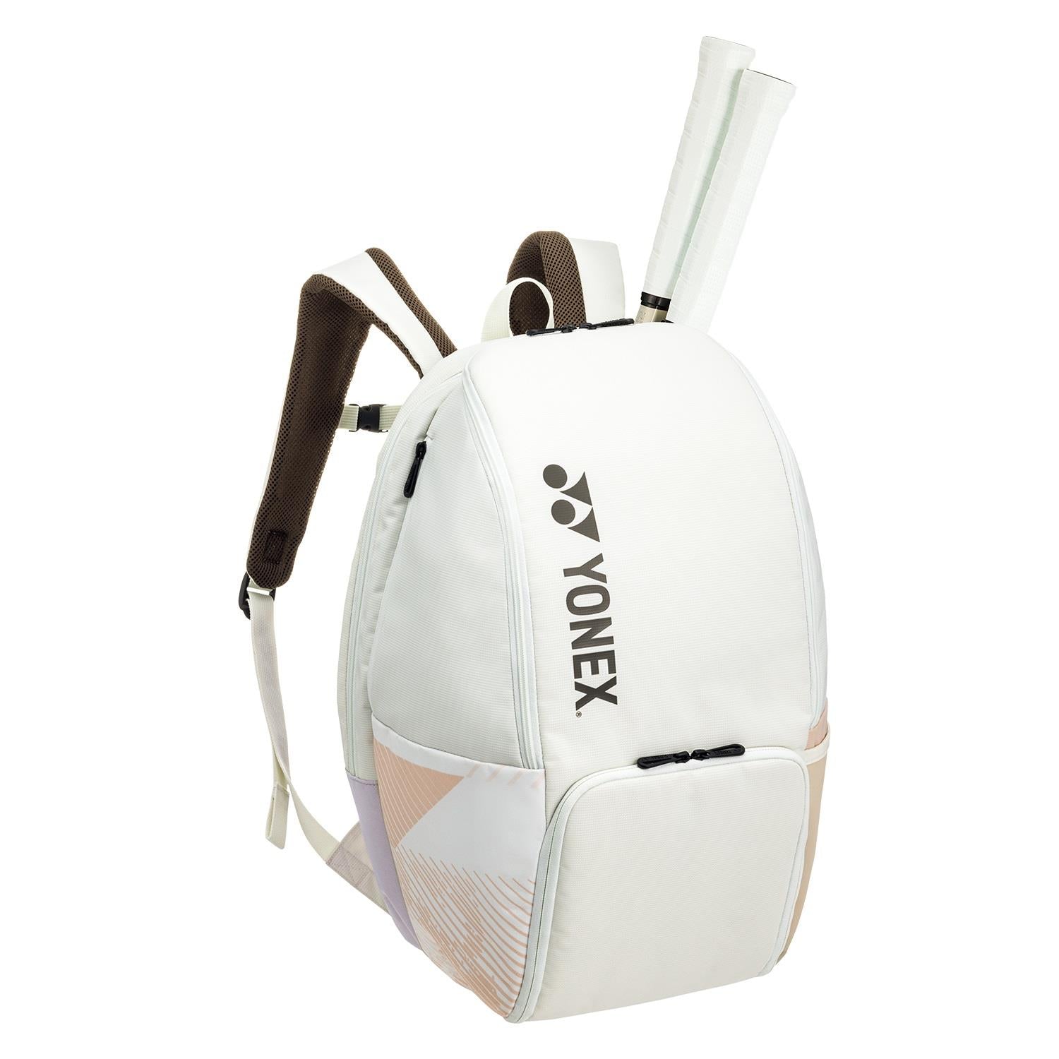 The Yonex 92412BEX Pro Badminton Backpack in Sand Beige, featuring white accents and the iconic Yonex logo, is equipped with two shoulder straps and offers specialized racket storage with compartments that extend from the top.