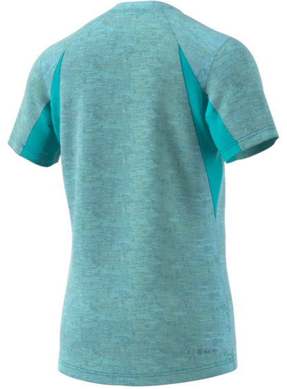 Back view of the ADIDAS Mens Freelift Badminton T-Shirt in light blue, showcasing a subtle heathered texture. This adidas shirt is ideal for athletic activities, featuring dark teal side panels and raglan sleeves. It's crafted from breathable fabric with moisture-absorbing technology.