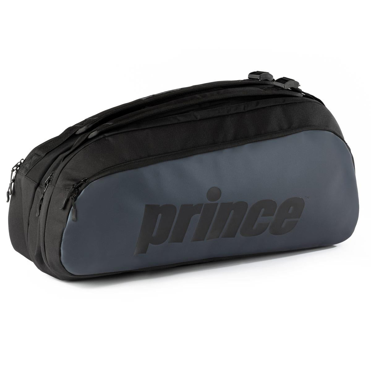 The Prince Tour 2 Comp 6 Racket Badminton Bag in black is a sleek and stylish choice for carrying your rackets and other gear. Featuring multiple zippered compartments, it prominently displays the "Prince" logo on the side. Balancing style with functionality, it is ideal as both a tennis and badminton bag.