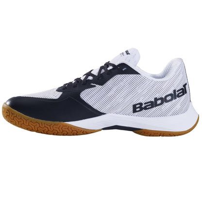 The Babolat Shadow Spirit 2 Men's Badminton Shoes in white and black feature a gum sole designed for peak indoor performance. The mesh upper provides enhanced breathability, and the Michelin rubber offers superior grip. The sporty design is completed with black accents and the iconic Babolat logo.