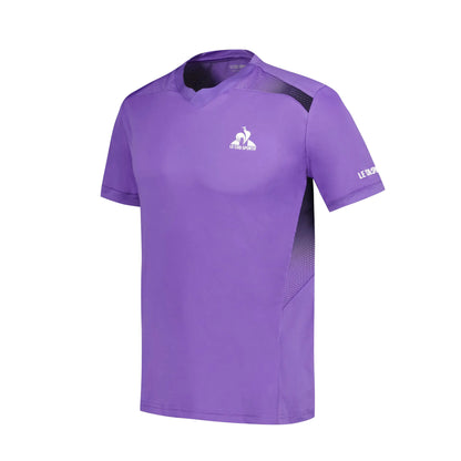 Introducing the Le Coq Sportif Pro Mens Badminton T-Shirt in Chive Blossom, a stylish sports tee designed for optimal comfort. Made from breathable polyester, it features a v-neck and short sleeves with dark mesh panels for enhanced ventilation. Small white logos on the chest and sleeve add an elegant touch to this performance-oriented shirt.