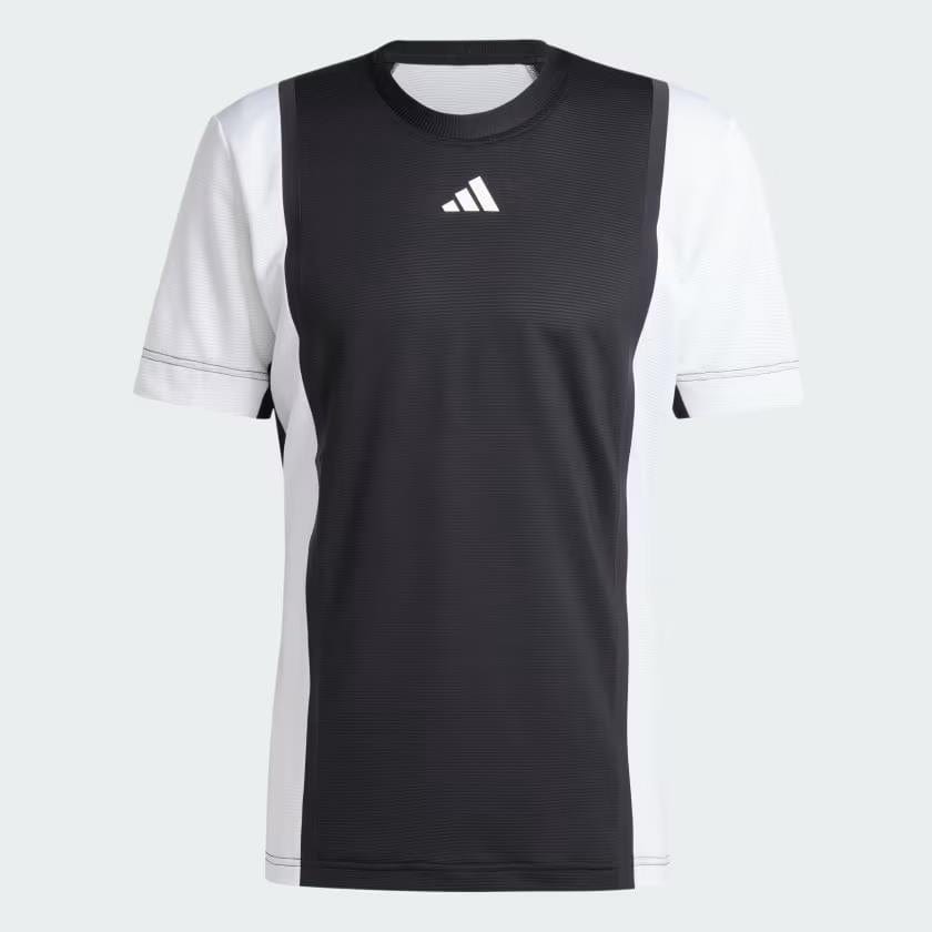 The adidas Men's Pro Freelift 3D Badminton T-Shirt in Black and White is a stylish athletic shirt adorned with the iconic adidas logo on the chest. This shirt features HEAT.RDY technology for enhanced breathability, making it ideal for any sporting activity. With its contrast side panels and straightforward round neckline, it provides both comfort and flair.