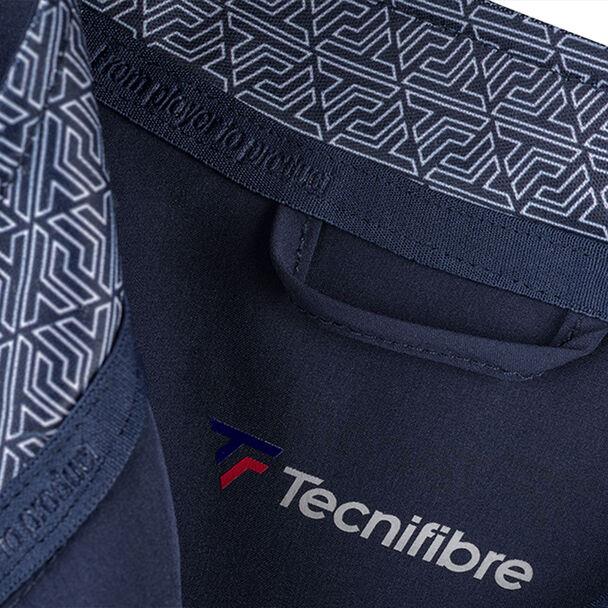 Close-up of a dark blue fabric with a light gray geometric pattern on the waistband, featuring the windproof and water-repellent Tecnifibre logo prominently displayed below, showcasing a red and blue emblem. This design perfectly complements the Tecnifibre Men's Light Badminton Jacket in Marine.