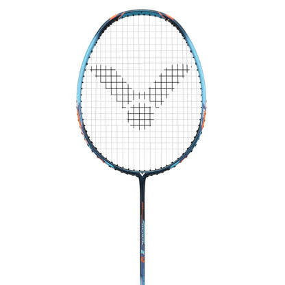 The Victor Thruster K 12 M Badminton Racket by Victor features a distinct blue and black frame with vibrant orange accents, showcasing a head heavy TK-12 design. It includes strings adorned with a pattern and a circular logo at the center, enhanced by the Fibre Reinforced System. The background is plain white.