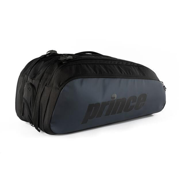 The Prince Tour 3 Comp 12 Racket Badminton Bag in black boasts a spacious compartment with dual zippers, ideal for transporting rackets. Its design prominently features the "Prince" logo in black on the gray side panel.