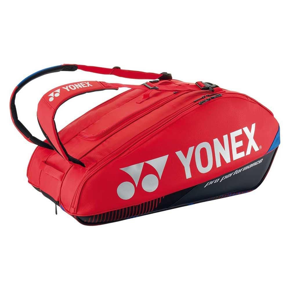 The Yonex 92429EX 9 Racket Pro Badminton Bag in Scarlet features two adjustable shoulder straps, a spacious central compartment, and multiple zippered pockets with Thermo Guard lining. The Yonex logo and branding are prominently displayed on the sides.