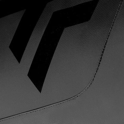 A close-up image showcases a textured tarpaulin fabric surface with black geometric shapes and two prominent chevron-like designs against a gray background, echoing the sharp contrast of the Tecnifibre Tour Endurance 2024 12 Racket Badminton Bag in Ultra Black by Tecnifibre.