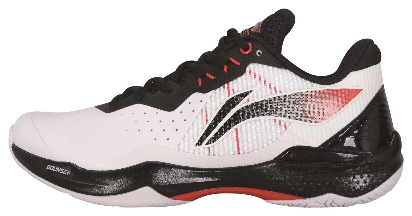 Introducing the Li-Ning Thunder Men's Badminton Shoe in White and Black: an athletic shoe accented with red, featuring Bounce+ Technology to enhance performance. It includes a textured sole, a sleek design, and perforated sides for improved breathability. The stylized logo alongside "Bounce+" on the sole adds to its modern aesthetic.