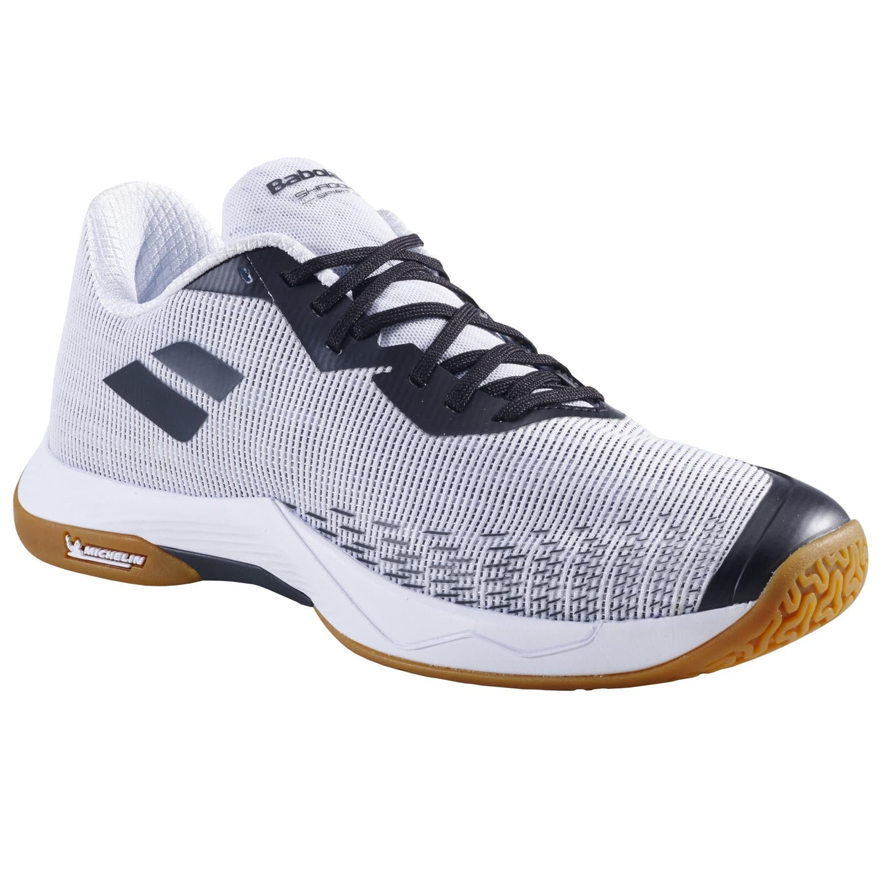 The Babolat Shadow Spirit 2 Men's Badminton Shoes, in white with black details, feature a textured pattern on the upper and a Michelin rubber gum sole. These shoes are branded on the side and tongue, designed by Babolat for optimal sports performance.