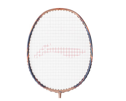 The Li-Ning BladeX 900 Sun Max 4U Badminton Racket, in a stunning Rose Gold finish, features a white stringed head with a central red pattern that provides responsive and precise control, beautifully showcased against a clean white background.