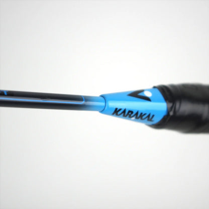 Close-up of a black and blue Karakal CB-3 2.1 Badminton Racket handle against a plain white background, ideal for beginner players seeking quality gear.