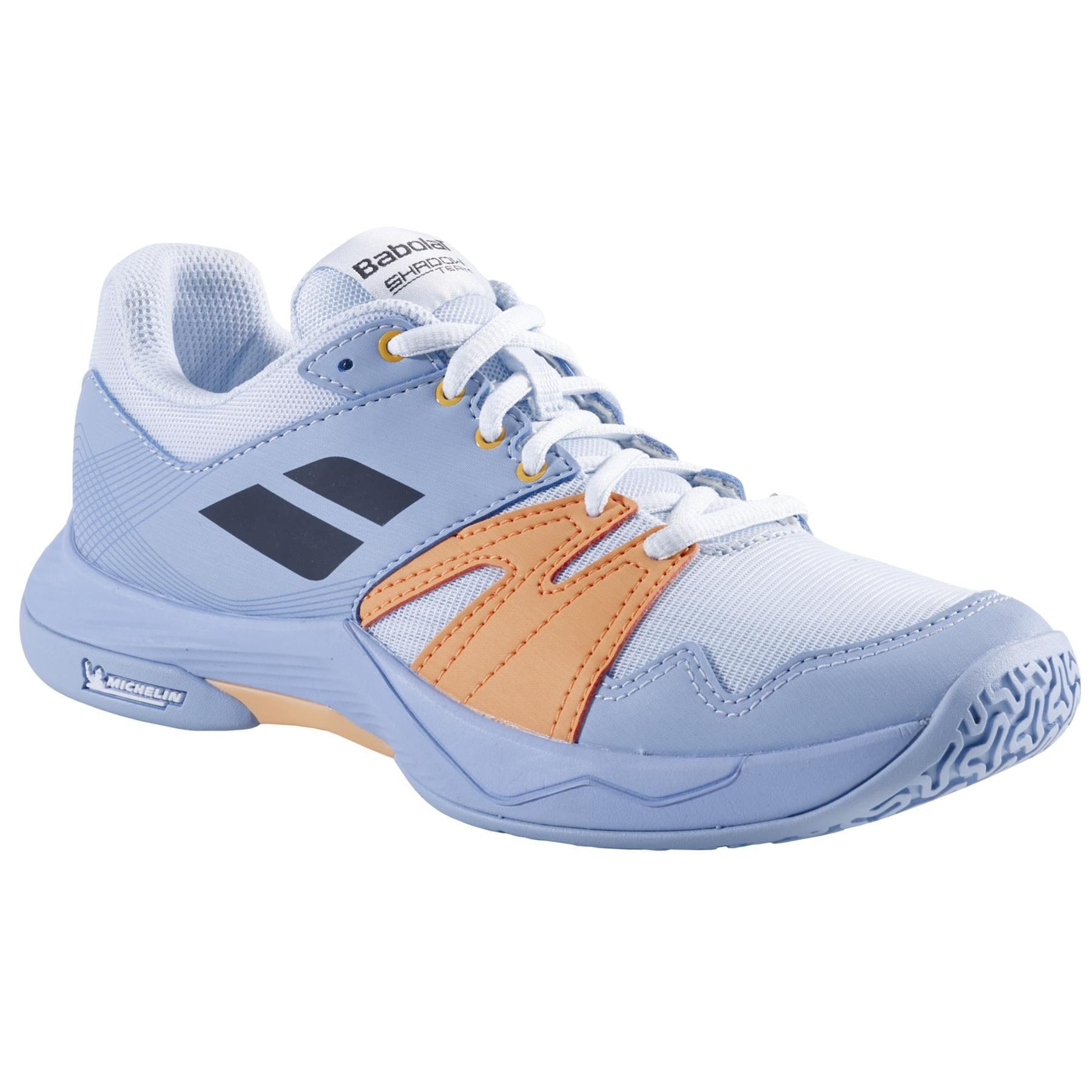 Introducing the Babolat Shadow Team 2 Women's Badminton Shoes in light blue, featuring orange accents, black stripes, and white laces. These shoes showcase the Babolat branding on the tongue and a patterned Michelin rubber sole designed for superior grip on the court.