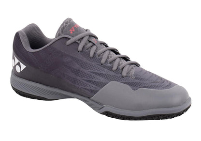 The Yonex Power Cushion Aerus Z2 Wide Men's Badminton Shoes in Dark Grey feature a sleek design with a lace-up closure and the advanced Power Cushion technology. Adorned with a side pattern and logo near the heel, these shoes also offer a textured sole for excellent grip. Additionally, the Synchro-Fit Insole enhances comfort and support inside the shoe.