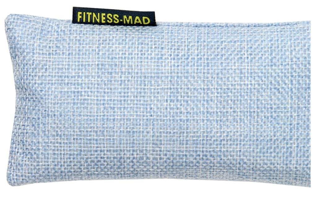 A light blue woven eye pillow showcasing the "Fitness Mad" label in yellow text. The pillow is crafted with a textured, crosshatch fabric infused with active charcoal, serving as the Fitness Mad Sports Odour Absorber to maintain its freshness and appeal.