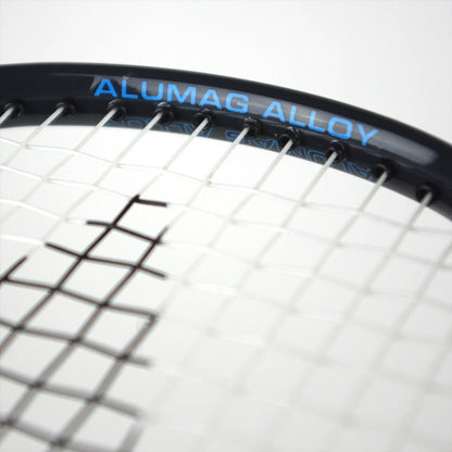 Close-up of a tennis racket with white strings. The frame is black, featuring "ALUMAG ALLOY" in blue. With an isometric head design similar to the Karakal CB-3 2.1 Badminton Racket, the focus remains on the top part of the racket head, making it ideal for beginners honing their skills.