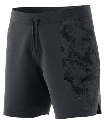 These ADIDAS Men's Paris Ergo Badminton Shorts in Carbon showcase a dark design, highlighted by a black abstract pattern on one side. They feature an elastic waistband and drawstrings. Inspired by clay surface graphics, these shorts are crafted with HEAT.RDY technology to ensure optimal performance and breathability.