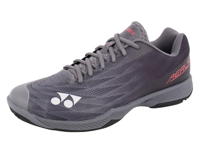 The Yonex Power Cushion Aerus Z2 Wide Men's Badminton Shoes in Dark Grey are athletic shoes with a stylish design, boasting red and white accents, including the Yonex logo on the side. They feature a textured upper, grey laces, and the Yonex Power Cushion sole, making them ideal for badminton or active wear.