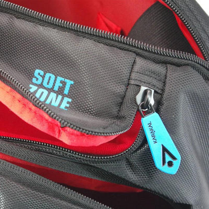 A close-up of the Karakal Pro Tour 30 2.1 Badminton Backpack in black and blue reveals its multiple zippered compartments. One zipper pull features a blue tag inscribed with "KAVU" and a logo, while inside one compartment, "SOFT ZONE" is printed in blue, reminiscent of the characteristic design elements.