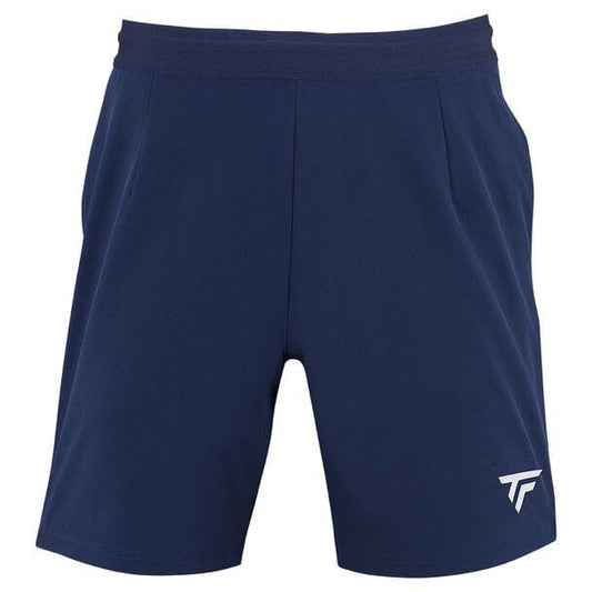 The Tecnifibre Men's Team Badminton Short in marine features a subtle white stylized logo on the bottom left. Designed for superior lightness and excellent ventilation, these shorts have an elastic waistband and a minimalist design ideal for athletic performance.