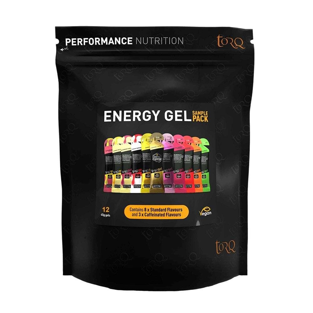 The Torq Gel Sample Pack - Assorted 12 Pack is a sleek black package containing a variety of energy gel sachets from Torq. It includes 12 sachets, with 9 standard flavors and 3 caffeinated options. Highlighting the TORQ Fuelling System and multi-transport carbohydrates, this product focuses on performance nutrition and is suitable for vegans.