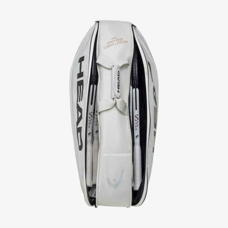 A top view of the HEAD Pro X Racket Bag - L - YUBK in white reveals a packed interior holding several racquets, reminiscent of those used by Novak Djokovic. The "HEAD" brand name is prominently displayed on the sides, and it features zippers and pockets engineered for optimal performance, set against a plain white background.