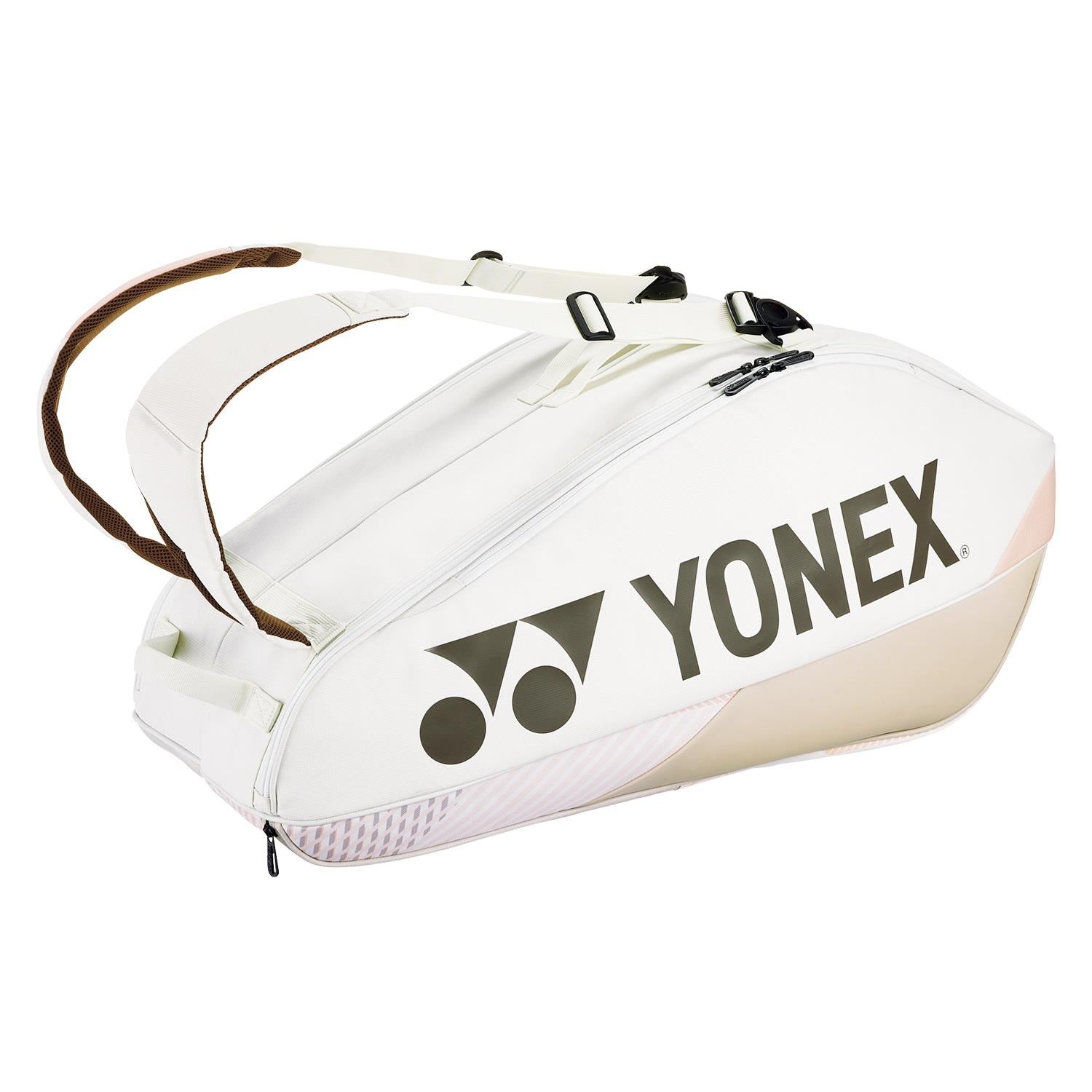 The Yonex 92426EX 6 Racket Pro Badminton Bag in sand beige comes with a spacious main compartment that can hold up to six rackets. It includes two shoulder straps and prominently features the Yonex logo on its side.