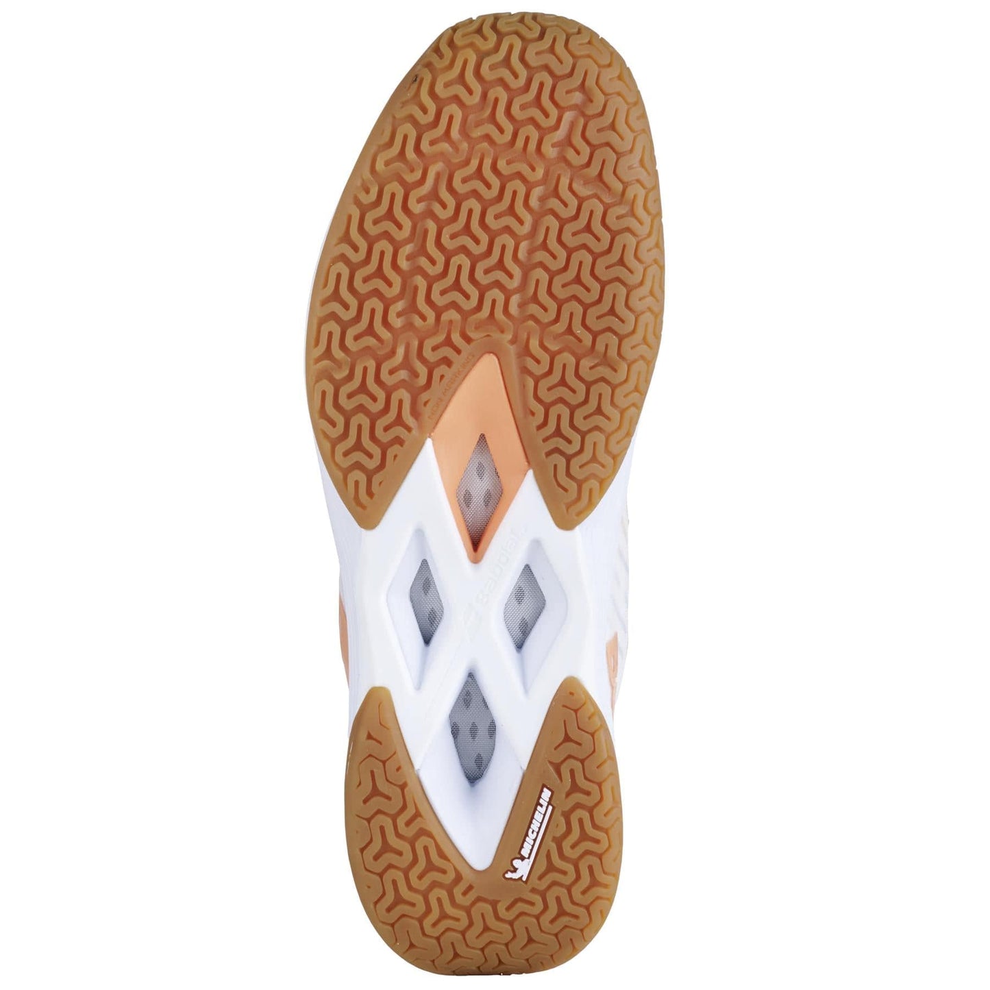 The image showcases the sole of the Babolat Shadow Tour 5 Women's Badminton Shoes, featuring a brown textured rubber pattern with diamond-shaped cutouts. The upper portion of this lightweight sole includes white and yellow accents, along with a small Babolat logo in white text on the bottom left, providing both style and support.