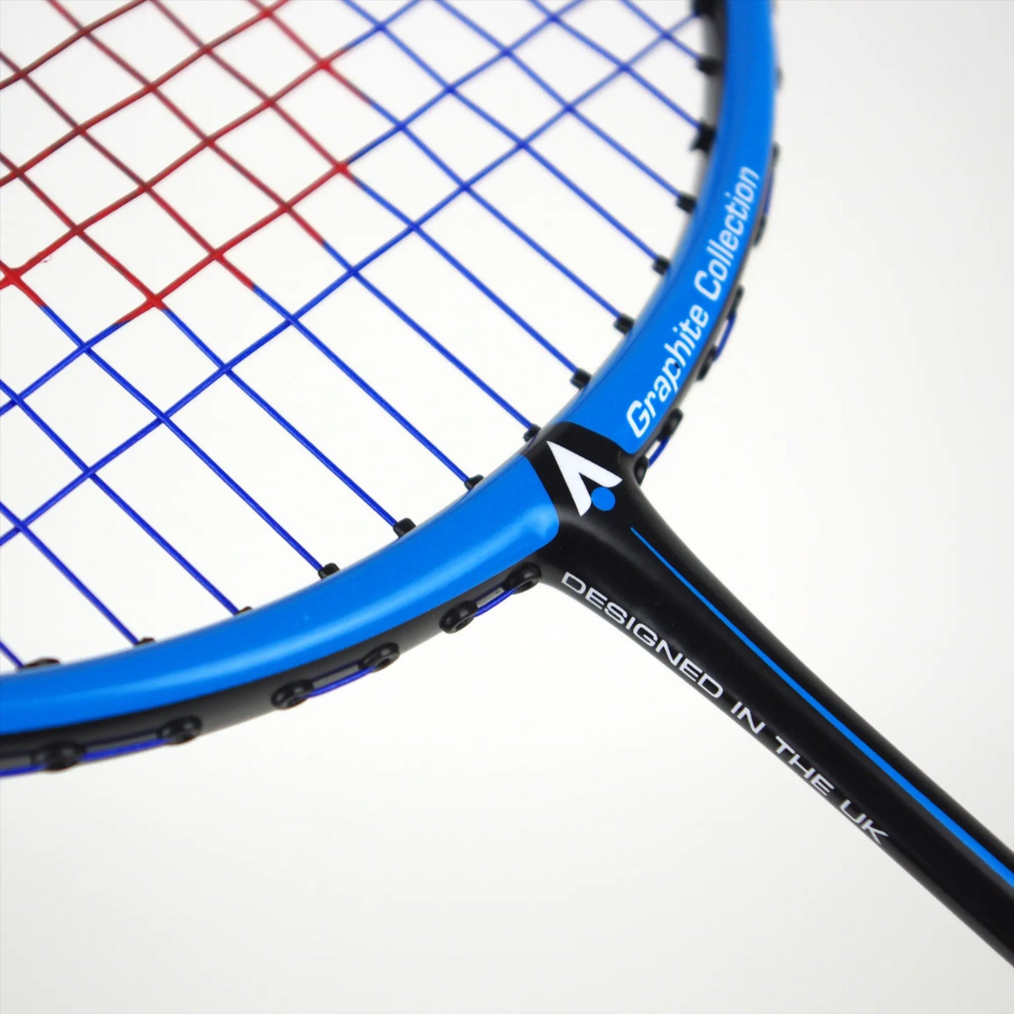 Close-up of a black and blue tennis racket with intricately woven colored strings. The isometric square head prominently displays the text "Graphite Collection" and "Designed in the UK." The focus is on the upper section of the racket's head, similar to a Karakal BZ 50 2.1 Badminton Racket, highlighting its angled shaft.