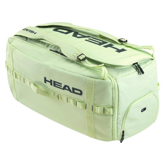 The HEAD Pro Duffle Badminton Bag L - LLAN is a spacious, light green duffel bag featuring black "HEAD" logos, ideal for badminton enthusiasts. Designed by HEAD, this bag boasts multiple compartments and zippers along with sturdy handles. It is set against a white background and incorporates climate control technology to ensure durability.