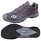 The Yonex Power Cushion Aerus Z2 Wide Men's Badminton Shoes in dark grey offer ultimate comfort with their signature Power Cushion technology, complemented by a textured sole for enhanced grip. The top view of the shoe highlights its side profile, and the bottom view showcases its tread pattern.