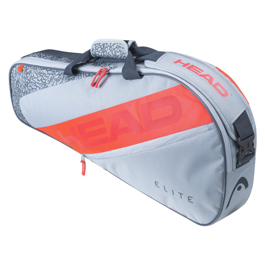 The HEAD Elite 3R 3 Racket Badminton Bag in grey and orange is a stylish tennis bag with the brand name "HEAD" prominently displayed. It features a durable construction and includes both handles and an adjustable shoulder strap for versatile carrying options. The "ELITE" bag design has a textured pattern on top, making it ideal for use as a racket badminton bag as well.