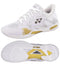 Introducing the Yonex Power Cushion Eclipsion Z3 Men's Badminton Shoes in White and Gold. These stability shoes are designed for badminton or indoor sports, featuring a breathable mesh upper with gold and gray accents. Enhanced with a Lateral Shell for extra support and equipped with a durable sole featuring traction patterns for superior grip, they offer optimal performance on the court.