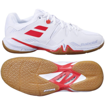 White and lavender Babolat Shadow Spirit 2023 women's badminton shoes with gum soles, shown from the side and bottom. The design combines smooth and textured surfaces, along with branding on both the side and sole. Equipped with Babolat Shadow Spirit technology, these shoes provide enhanced heel cushioning for every step.