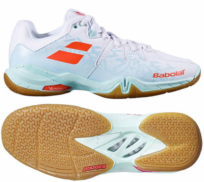 The Babolat Shadow Spirit Women's Badminton Shoes in White and Light Blue showcase a textured orange logo. These shoes feature a gum-colored gripsole with a distinct tread pattern, complemented by mesh panels and reinforcement in essential areas for enhanced support.