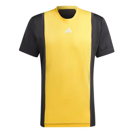 The adidas Men's Pro Freelift 3D Badminton T-Shirt in Spark Yellow and Black features a vivid yellow front panel paired with black sides and sleeves. It includes Freelift 3D sleeves for improved mobility, a subtle white logo near the neckline, and utilizes HEAT.RDY technology to ensure you stay cool. The overall design is sleek and athletic.