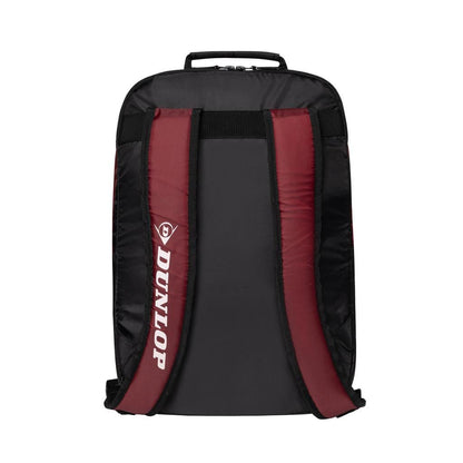 The Dunlop CX Club Badminton Backpack in black and red is displayed from the back, showcasing two padded shoulder straps with the Dunlop logo featured on one strap. The backpack includes a convenient top handle and a dedicated racket compartment for optimal ease.