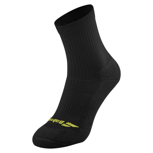 A single black ankle-length sock from Babolat's Pro 360 collection, featuring a ribbed texture and a distinctive "Balega" in yellow near the toe area, is displayed from the side against a white background, highlighting its underfoot cushioning.