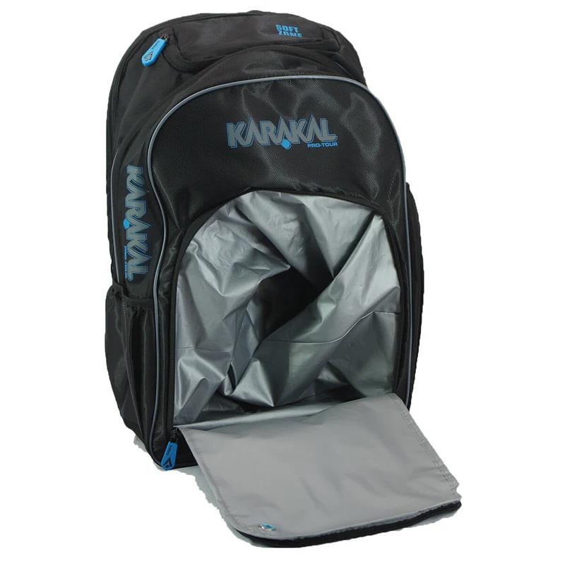 The Karakal Pro Tour 30 2.1 Badminton Backpack in black and blue, offered by Karakal, features a sleek design with blue accents and branding. It has a generous capacity of 30 liters, with an open main compartment revealing a silver interior. The front flap extends to highlight its zippered design.