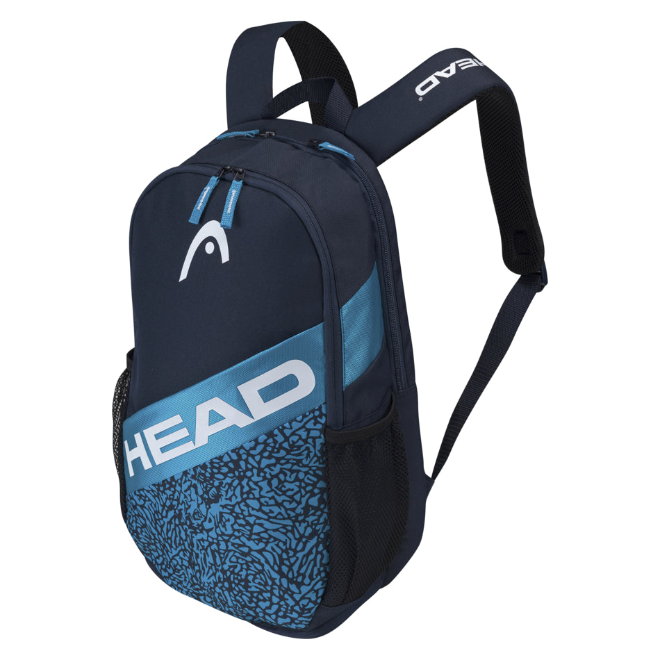 A HEAD Elite Backpack in Blue Navy, showcasing "HEAD" written prominently in bold white and blue lettering. It features a patterned front with blue accents, includes adjustable black straps, a top handle, mesh side pockets, and a padded compartment for secure storage of your essentials.